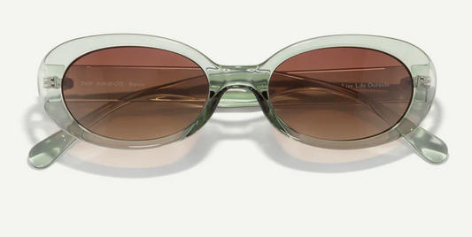 oval clear frame sunglasses with brown lenses on a white background