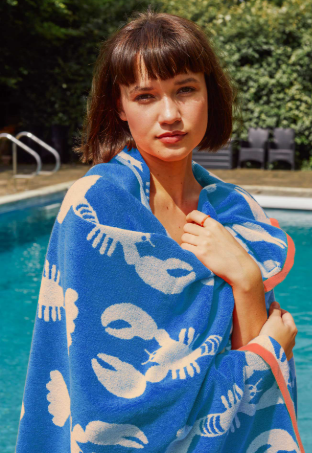 Woman at the pool with lobster towel wrapped around her