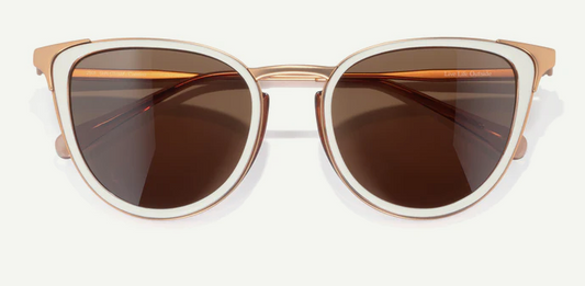 cateye sunglasses with gold frame and brown lenses on a white background