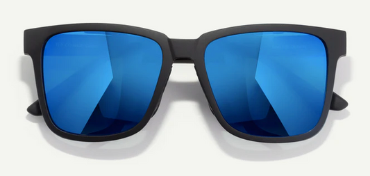 Sunglasses with blue reflective lenses and black frames on a white background