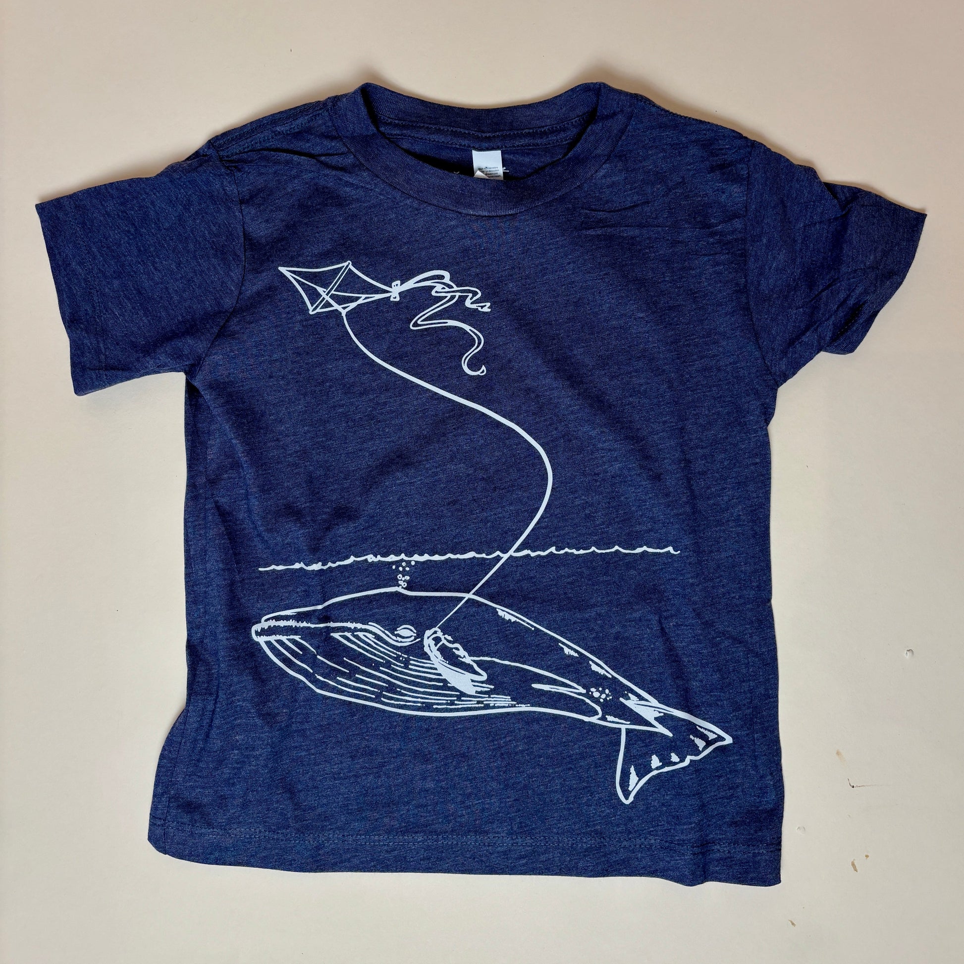 Original whale & kite artwork by Animal Instincts Apparel

Soft, durable kids’ tee in heather navy

Printed/embroidered in-house at our Northampton, MA shop