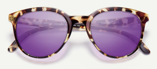 Sunglasses with purple lenses and tortoiseshell frame on a white background