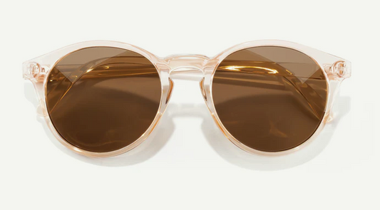 Clear cateye framed sunglasses with brown lenses on a white background