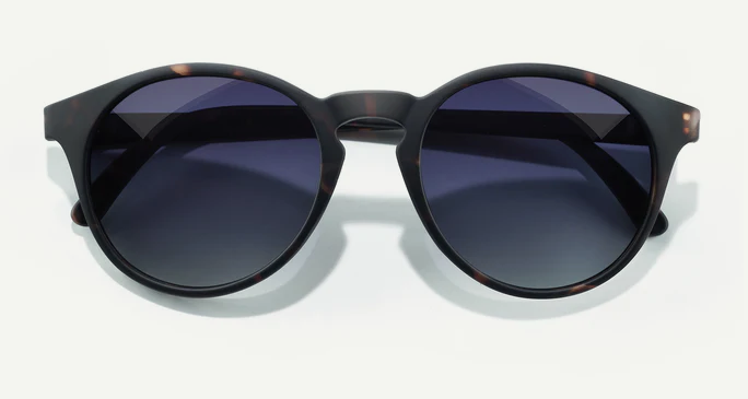 Round sunglasses with dark lenses on a white background