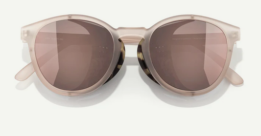 Sunglasses with a beige frame and brown lenses on a white background