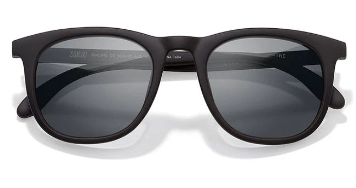 Black sunglasses with dark lenses on a white background