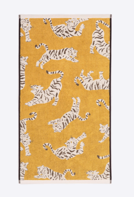 Yellow hand towel with white tigers jumping pattern, black trim