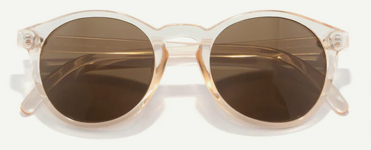 Round cateye sunglasses with clear frame and brown lenses on a white background